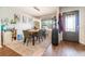 Inviting dining room featuring a modern chandelier, stylish decor, and natural light from the window at 1993 Excalibur Dr, Orlando, FL 32822