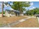 A cozy single-story home with a well-maintained front yard and mature tree, offering shade and curb appeal at 1993 Excalibur Dr, Orlando, FL 32822
