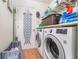 Functional laundry room with washer, dryer, shelving, and extra storage space at 1993 Excalibur Dr, Orlando, FL 32822