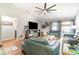 Inviting living room featuring wood floors, a ceiling fan, and sliding glass doors to the backyard at 1993 Excalibur Dr, Orlando, FL 32822