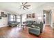 Spacious living room featuring a large ceiling fan, hardwood floors, and comfortable seating, perfect for relaxing at 1993 Excalibur Dr, Orlando, FL 32822