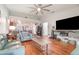 Open-concept living room boasts wood floors and a large entertainment center at 1993 Excalibur Dr, Orlando, FL 32822