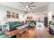 Open-concept living room with hardwood floors, stylish furniture, and seamless flow to the kitchen and dining areas at 1993 Excalibur Dr, Orlando, FL 32822