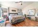 Bright main bedroom with wood floors, a ceiling fan, and plenty of natural light at 1993 Excalibur Dr, Orlando, FL 32822