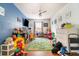 Spacious playroom with hardwood floors, colorful decor, and a ceiling fan at 1993 Excalibur Dr, Orlando, FL 32822