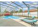 Beautiful screened pool with lounge chairs, patio furniture, and a white privacy fence for relaxing outdoor living at 1993 Excalibur Dr, Orlando, FL 32822