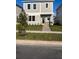 Inviting two-story home with stone accents, lush green lawn, and a bright green front door at 1999 Iorio St, St Cloud, FL 34771