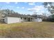 This backyard features a partially-covered patio and view of wooded canal at 2028 Sussex Rd, Winter Park, FL 32792