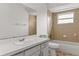 This bathroom has a vanity, toilet, and a tiled shower over tub at 2028 Sussex Rd, Winter Park, FL 32792