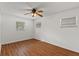 This bedroom features wood-look floors, three windows, and a ceiling fan at 2028 Sussex Rd, Winter Park, FL 32792