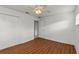 Bright bedroom with wood-look floors, ceiling fan, closet, and white doors at 2028 Sussex Rd, Winter Park, FL 32792