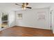Bedroom with ceiling fan and natural light provided by the three windows, complimented by wood flooring at 2028 Sussex Rd, Winter Park, FL 32792