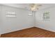 This bedroom features wood-look floors and a ceiling fan with light kit at 2028 Sussex Rd, Winter Park, FL 32792