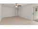 A well-lit and empty bedroom with tiled floors and a sliding glass door for backyard access at 2028 Sussex Rd, Winter Park, FL 32792