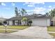 Single-story home featuring manicured landscaping and an attached two-car garage at 2028 Sussex Rd, Winter Park, FL 32792