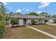 Inviting single-story home with a walkway leading to the front door and lush landscaping at 2028 Sussex Rd, Winter Park, FL 32792