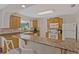 Bright kitchen featuring granite counters, breakfast bar, stainless steel appliances, and natural light at 2028 Sussex Rd, Winter Park, FL 32792