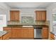 Kitchen showcases wood cabinets, granite countertops, and stainless steel appliances at 2028 Sussex Rd, Winter Park, FL 32792