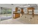 Bright kitchen features wood cabinets, granite countertops, and tile backsplash, with a view to the backyard through sliding glass doors at 2028 Sussex Rd, Winter Park, FL 32792