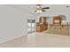 Open kitchen featuring wood cabinets, tile floors, breakfast bar, and view to the backyard at 2028 Sussex Rd, Winter Park, FL 32792