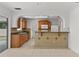 Bright kitchen features wood cabinets, granite countertops, and tile backsplash, with a view to the backyard through sliding glass doors at 2028 Sussex Rd, Winter Park, FL 32792