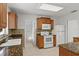 Kitchen features wood cabinets, granite countertops, a white refrigerator, and modern appliances at 2028 Sussex Rd, Winter Park, FL 32792