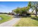 A tranquil backyard provides a serene escape with views of the pond, lush lawn, and partial fencing at 2260 The Oaks Blvd, Kissimmee, FL 34746
