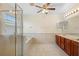 This bathroom features a glass shower, bathtub, double sink, and tile floors at 2260 The Oaks Blvd, Kissimmee, FL 34746