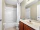 Bathroom featuring a shower and bath combo, a toilet, and a sink at 2260 The Oaks Blvd, Kissimmee, FL 34746
