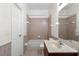Bathroom featuring a shower and bath combo, a toilet, and a sink at 2260 The Oaks Blvd, Kissimmee, FL 34746