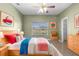 bedroom with bright accents, window views and tile flooring at 2260 The Oaks Blvd, Kissimmee, FL 34746