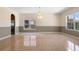 Spacious dining room with neutral colors, large windows, and elegant chandelier lighting at 2260 The Oaks Blvd, Kissimmee, FL 34746