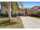 Inviting two-story home features a well-maintained front yard, mature landscaping, and a spacious driveway at 2260 The Oaks Blvd, Kissimmee, FL 34746