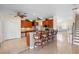Open concept kitchen with granite island, stainless appliances, wood cabinetry and tile floors at 2260 The Oaks Blvd, Kissimmee, FL 34746
