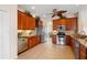 Spacious kitchen featuring granite countertops, tile floors, and stainless steel appliances at 2260 The Oaks Blvd, Kissimmee, FL 34746