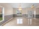 Spacious room with glossy floors, decorative chandelier and neutral wall colors at 2260 The Oaks Blvd, Kissimmee, FL 34746