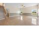 Large living room with tiled floor, neutral colors and a staircase at 2260 The Oaks Blvd, Kissimmee, FL 34746