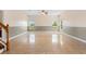 An expansive living room, bathed in natural light, showcases stylish tile flooring and a staircase leading to upper level at 2260 The Oaks Blvd, Kissimmee, FL 34746