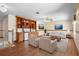 Living room with built in shelving, two chairs, a couch, coffee table, and hardwood floors at 2260 The Oaks Blvd, Kissimmee, FL 34746