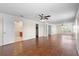 Large living room featuring wood floors, many windows, and access to the bathroom at 2260 The Oaks Blvd, Kissimmee, FL 34746