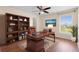 This office features a desk, chair, shelving, window, and wood floors at 2260 The Oaks Blvd, Kissimmee, FL 34746