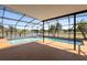 Relaxing screened-in pool area boasts clear views of the lake and surrounding greenery for the perfect outdoor retreat at 2260 The Oaks Blvd, Kissimmee, FL 34746