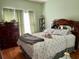 Cozy bedroom featuring a large bed with decorative pillows and traditional-style furniture at 24125 Peekskill St, Leesburg, FL 34748