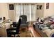 Bedroom with comfortable seating, desk area, and a cozy bed, great for relaxation and work at 24125 Peekskill St, Leesburg, FL 34748