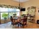 Bright dining area with a table setting, plenty of light, and display shelving at 24125 Peekskill St, Leesburg, FL 34748