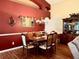 Elegant dining room with a classic table set, ornate accents, and hardwood floors at 24125 Peekskill St, Leesburg, FL 34748