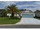 Inviting home featuring a lush green lawn and a spacious driveway at 24125 Peekskill St, Leesburg, FL 34748