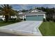 Charming single-story home with a well-manicured lawn and a two-car garage at 24125 Peekskill St, Leesburg, FL 34748