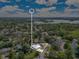 An aerial view shows the location of the home within a neighborhood that features mature landscaping and a lake at 2525 Venetian Way, Winter Park, FL 32789