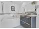 Modern bathroom featuring a soaking tub, sleek vanity, and mosaic tile accents at 2525 Venetian Way, Winter Park, FL 32789